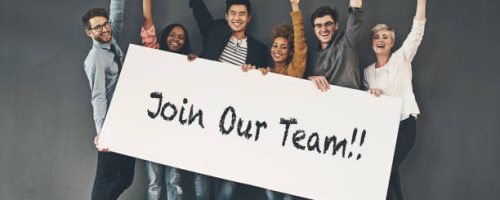 Studio shot of a diverse group of people holding up a placard against a grey background